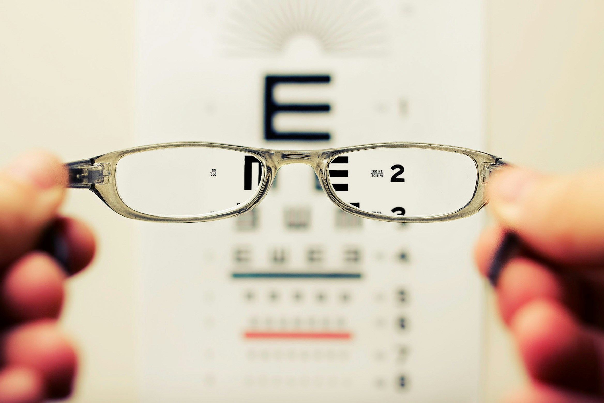 glasses held up to eye test strip