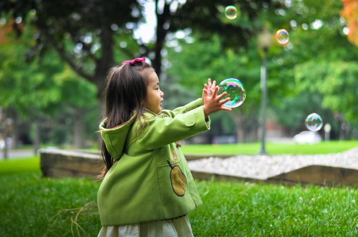 child catching a bubble
