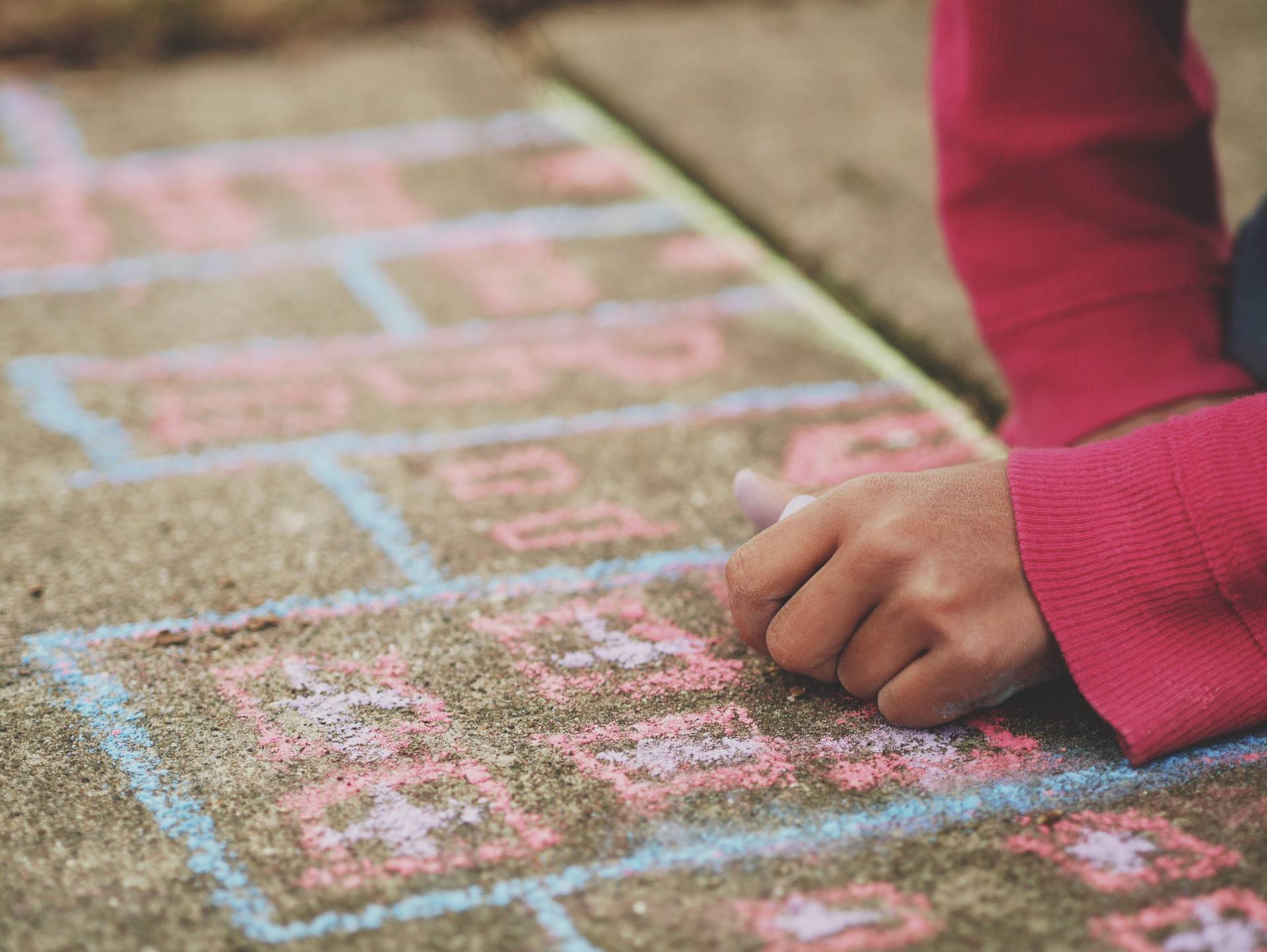 child drawing hopscotch